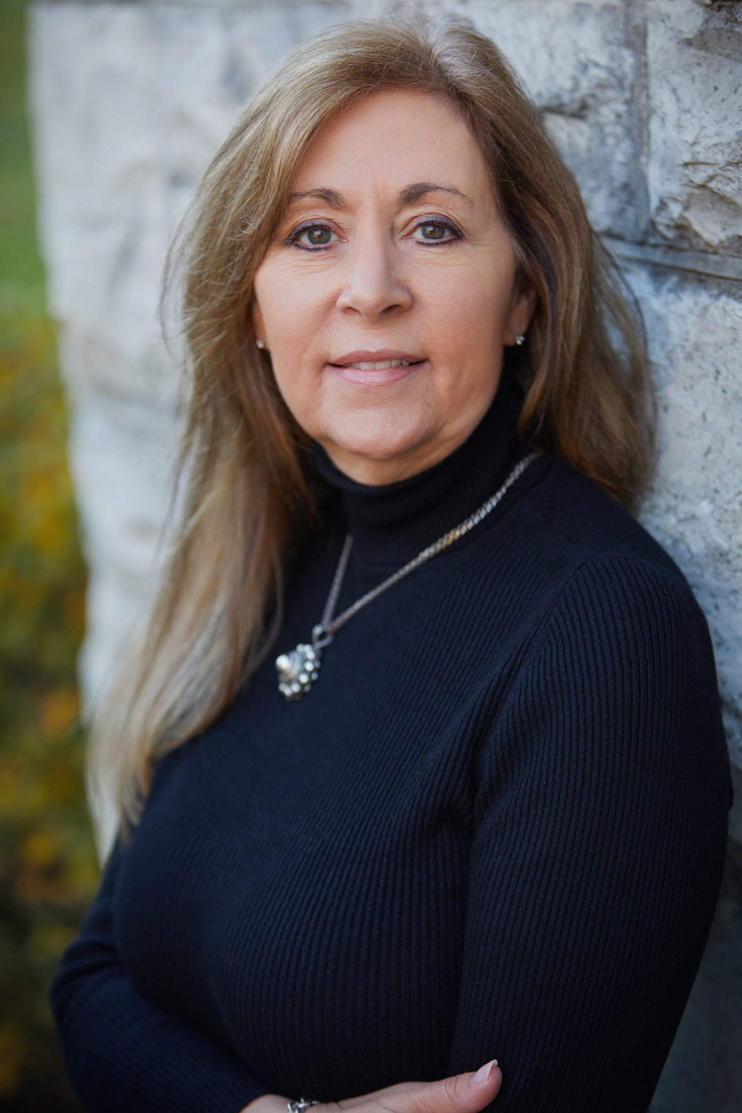 A headshot of a woman wearing a black turtle neck.