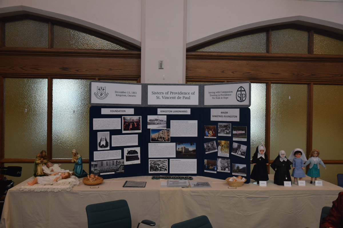 A poster display board on top of a table covered with a white tablecloth.